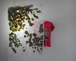 Kirsten Kötter: Objekt, 2013, Haselnuss- und Birkenblätter in Stoff mit Licht, bemaltes T-Shirt, 100 × 100 × 20 cm
